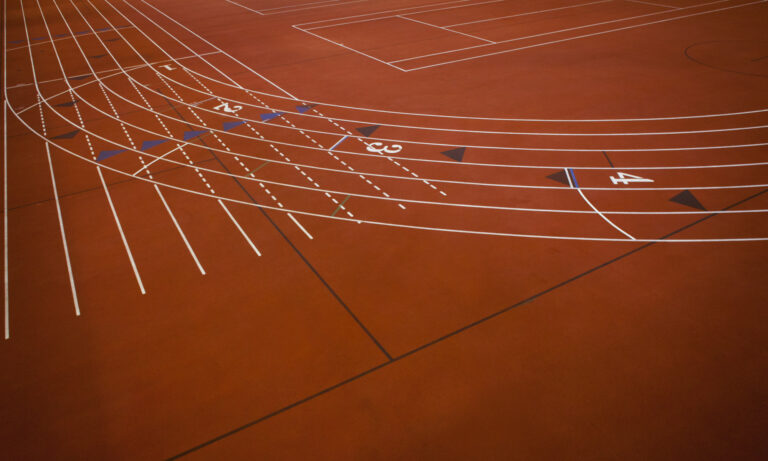Running Track,Running Track,A red running track, athletics ground, a corner section of track marked with lanes